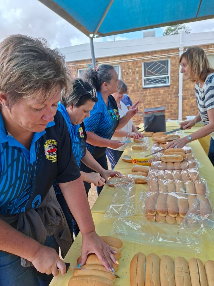 The Wild Buggers "Ladybugs" preparing hundreds of hot dog rolls for the charity boerewors lunch in Malmesbury.