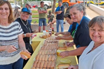 The Wild Buggers "Ladybugs" smiling while preparing rows of fresh rolls for the charity boerewors lunch at Goue Aar.