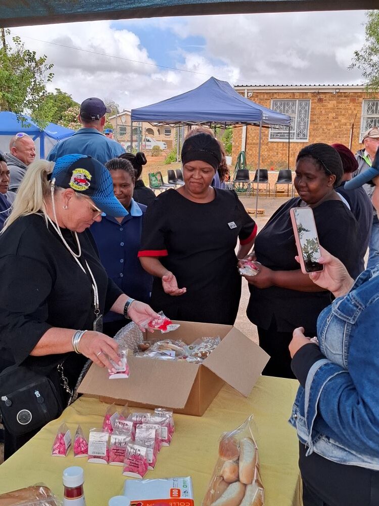 Wild Buggers club members distributing gift packs and treats to the hardworking staff members at the Goue Aar home in Malmesbury.