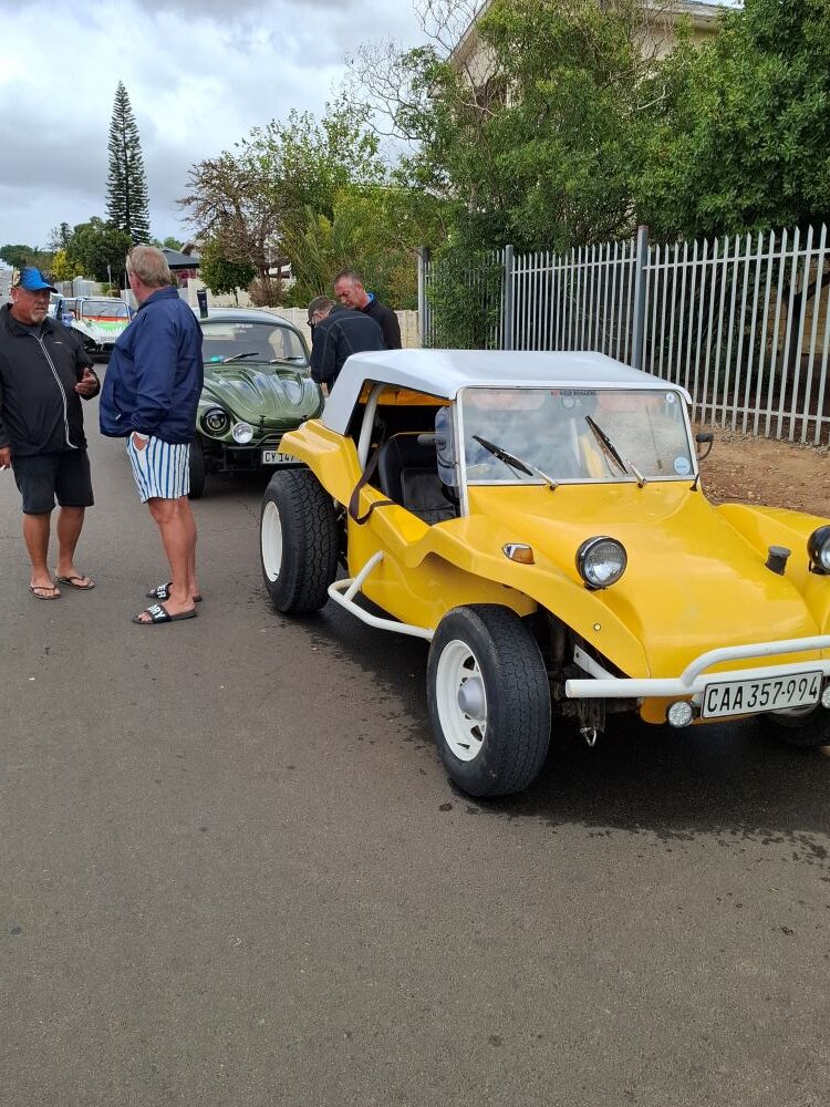 Jacques and Coralie’s yellow 1600 VW air-cooled Beamish beach buggy, "Dragonfly," parked on a street during a Wild Buggers club event.