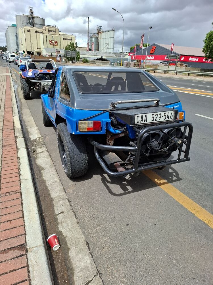 Rhoodie and Yolande Ackerman’s blue Kango beach buggy with a 1600 VW Golf motor parked on a Malmesbury street during a Wild Buggers club run.