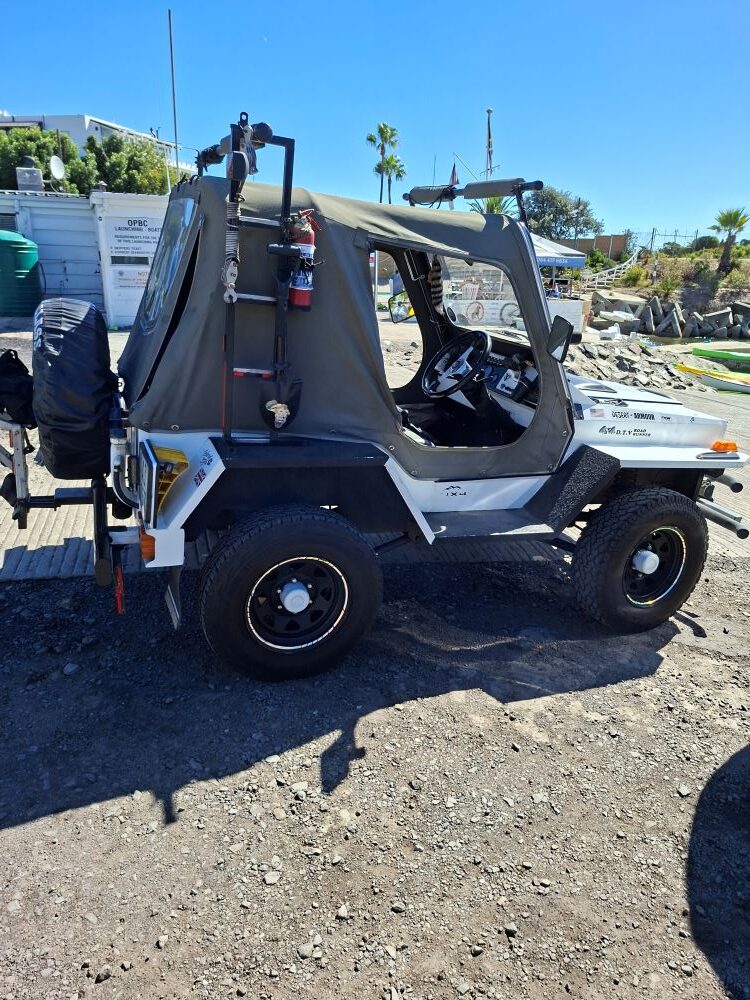 Faizal and Ayesha’s white Jeep with a Toyota motor swap and custom off-road gear parked at the Oceana Power Boat Club in Cape Town.