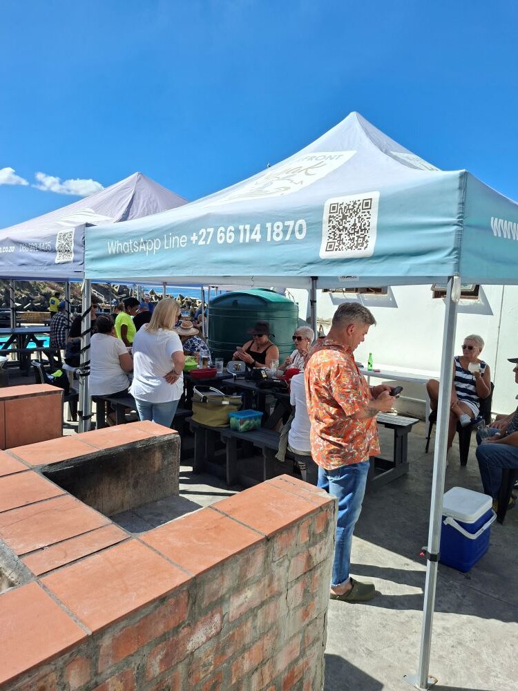 Wild Buggers club members relaxing under a gazebo at the Oceana Power Boat Club social event in Cape Town.