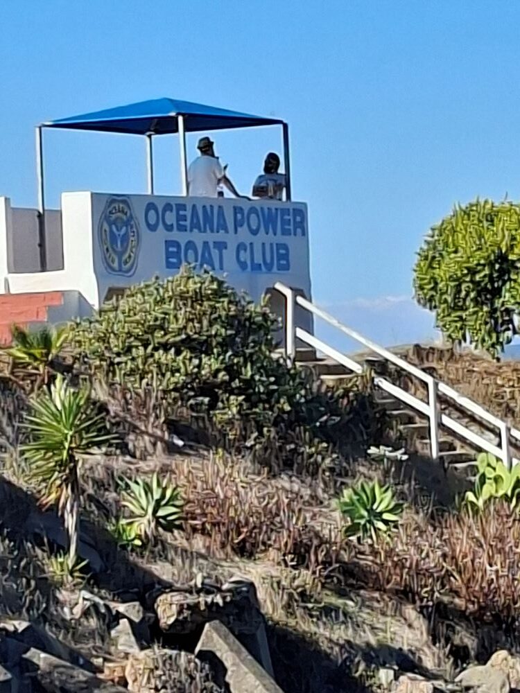 Wild Buggers Beach Buggy Club members relaxing and socializing at the Oceana Power Boat Club with scenic coastal views of Cape Town