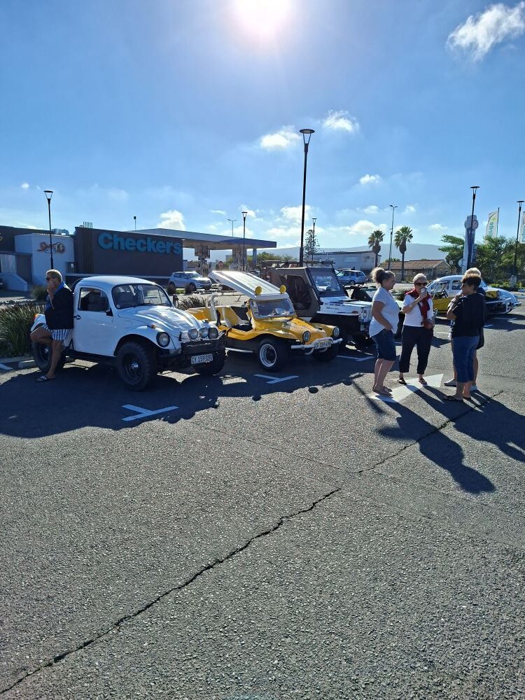 A line-up of custom VW Baja Bugs and beach buggies at Bothasig Square, Cape Town, during a Wild Buggers club run.