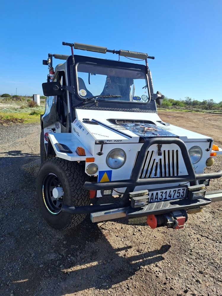 Faizal’s white Jeep parked at a West Coast pitstop during the Wild Buggers West Coast cultural experience Run, showing off classic club-run style on the scenic route from Cape Town.