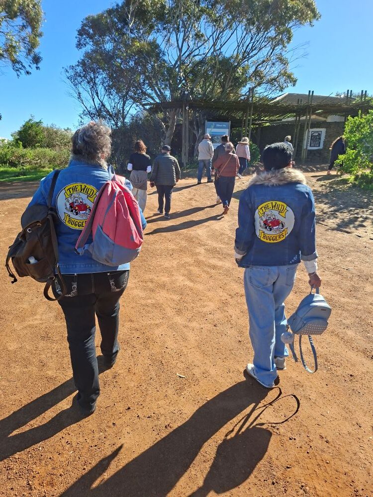 Wild Buggers members walking toward the !Khwa ttu entrance during the West Coast cultural experience Run, arriving at the San Heritage Centre on the West Coast.