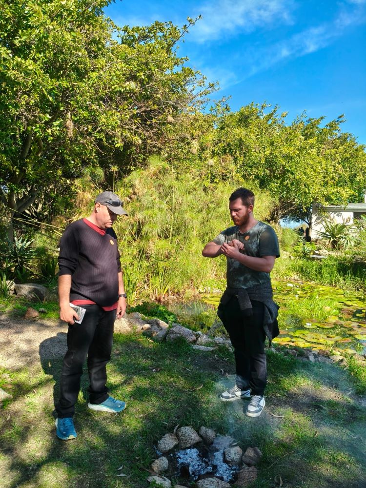 Wiehann and Bertus discussing medicinal plants in the Khoi San garden at !Khwa ttu during the Wild Buggers West Coast cultural experience Run, exploring the cultural and botanical side of the San Heritage Centre.