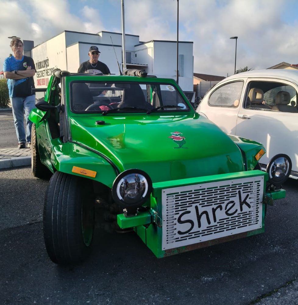 Anton Kleyn and Mickey’s green Kango beach buggy, Shrek, parked at the Bothasig meeting point before the Wild Buggers West Coast cultural experience Run, featuring a 1400 Nissan motor and classic Beach Buggy character.