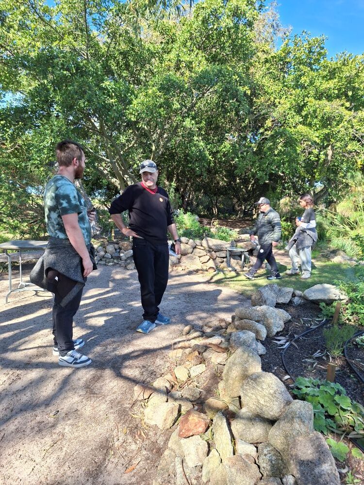 Wiehann and Bertus deep in conversation discussing medicinal plants in the indigenous garden at !Khwa ttu during the Wild Buggers West Coast cultural experience Run at the San Heritage Centre.
