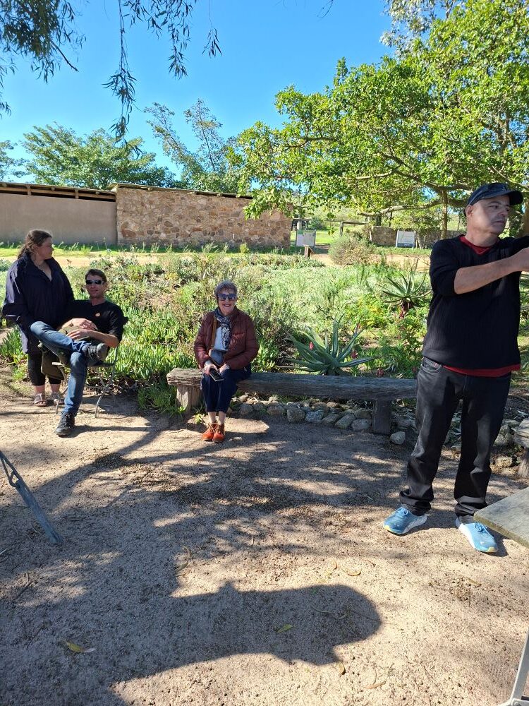 Wiehann, Jo-Ann, Lerene, and her partner relaxing in the indigenous medicinal garden at !Khwa ttu during the Wild Buggers West Coast cultural experience Run at the San Heritage Centre.