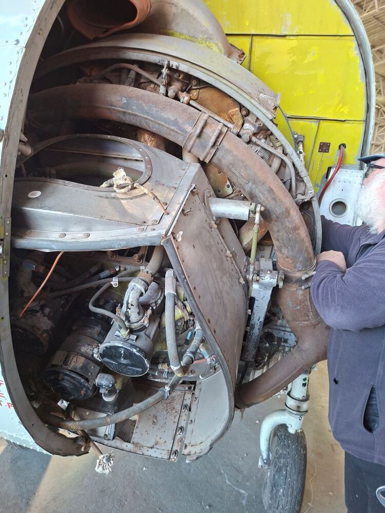 Wild Buggers club member Leon Visser getting a close-up look at the open nose turbine engine bay of a classic Westland Wessex helicopter at the Ysterplaat museum during a car cruise.
