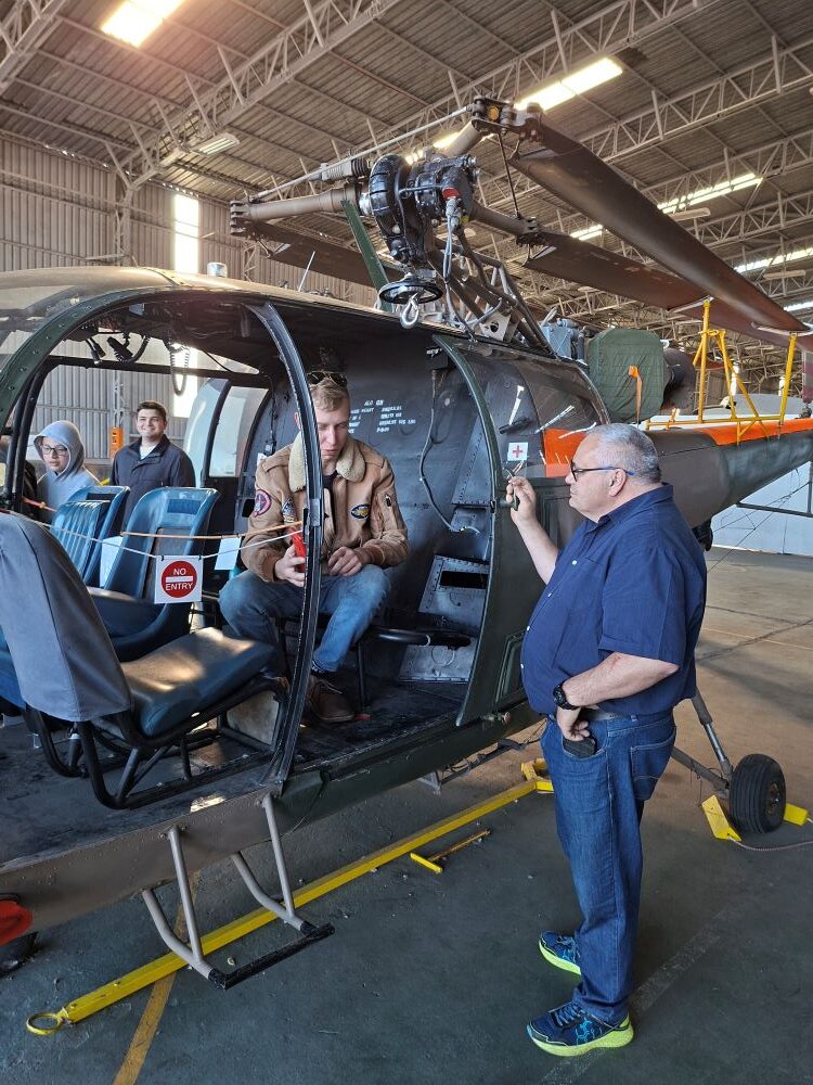 Wild Buggers club members Kyle Cato and Herbie Thiart examining the interior of a vintage Sud Aviation SA 316B Alouette III military helicopter inside a hangar at the South African Air Force Museum.