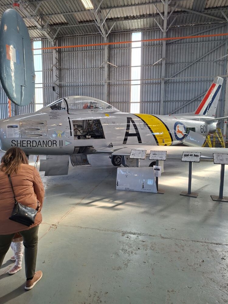 A vintage Canadair Sabre Mk 6 fighter jet named Sherdanor II on display inside the hangar at the South African Air Force Museum during a classic car club run.