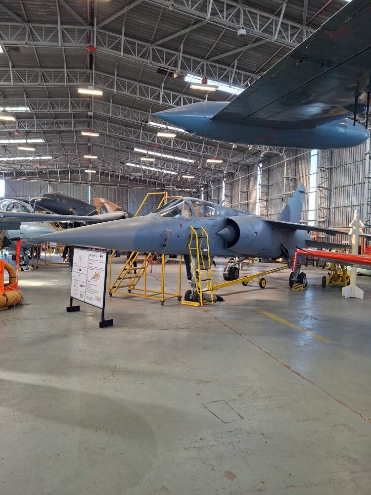 A vintage Mirage F1CZ fighter jet on static display at the South African Air Force Museum during a Wild Buggers club run for custom beach buggies, rugged Baja Bugs, and classic VW air-cooled vehicles.
