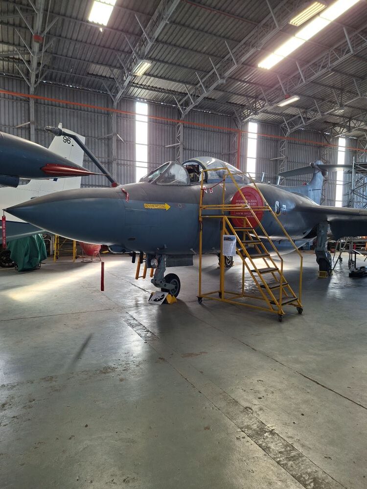 A vintage Blackburn Buccaneer strike aircraft on static display at the South African Air Force Museum during a Wild Buggers club run for custom beach buggies, rugged Baja Bugs, and classic VW air-cooled vehicles.
