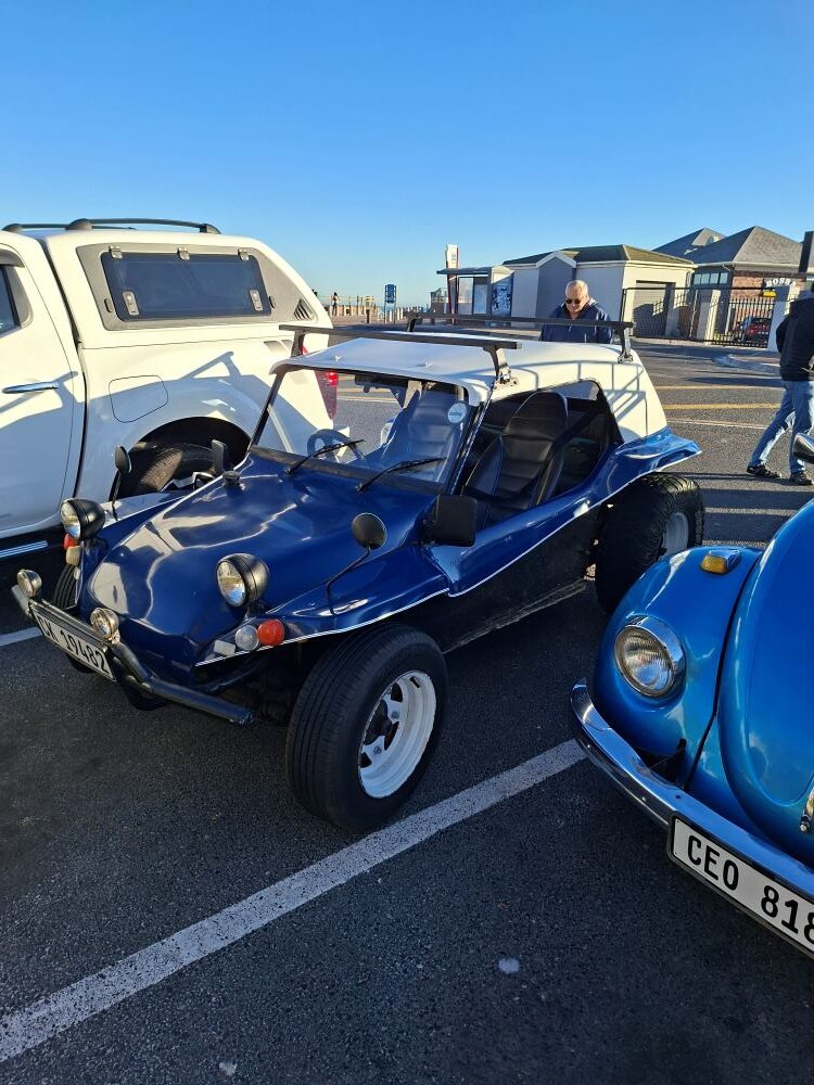 A blue and white Beamish beach buggy with a 1600 VW Beetle air-cooled motor parked at Woodbridge Island for a Cape Town car event.