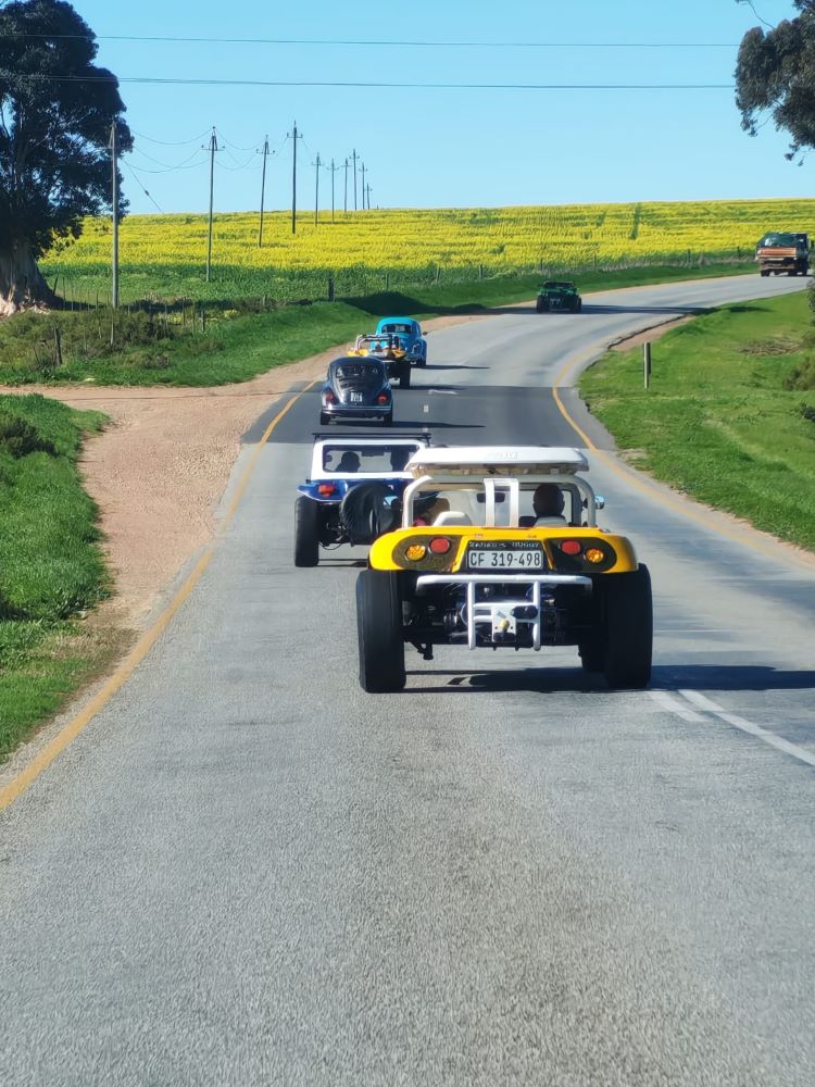 A scenic view from a classic VW air-cooled Beetle following a convoy of custom beach buggies, Baja Bugs, and other classic VW air-cooled vehicles on a winter cruise through the Western Cape countryside.