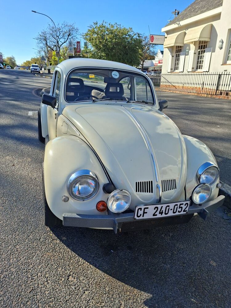 A classic old school VW Beetle, modified with a 1500 Datsun motor, parked at Cape to Rio Fisheries after the Wild Buggers club Propellers and Pistons Winter Cruise, an event celebrating beach buggy and air-cooled vehicle enthusiasts.