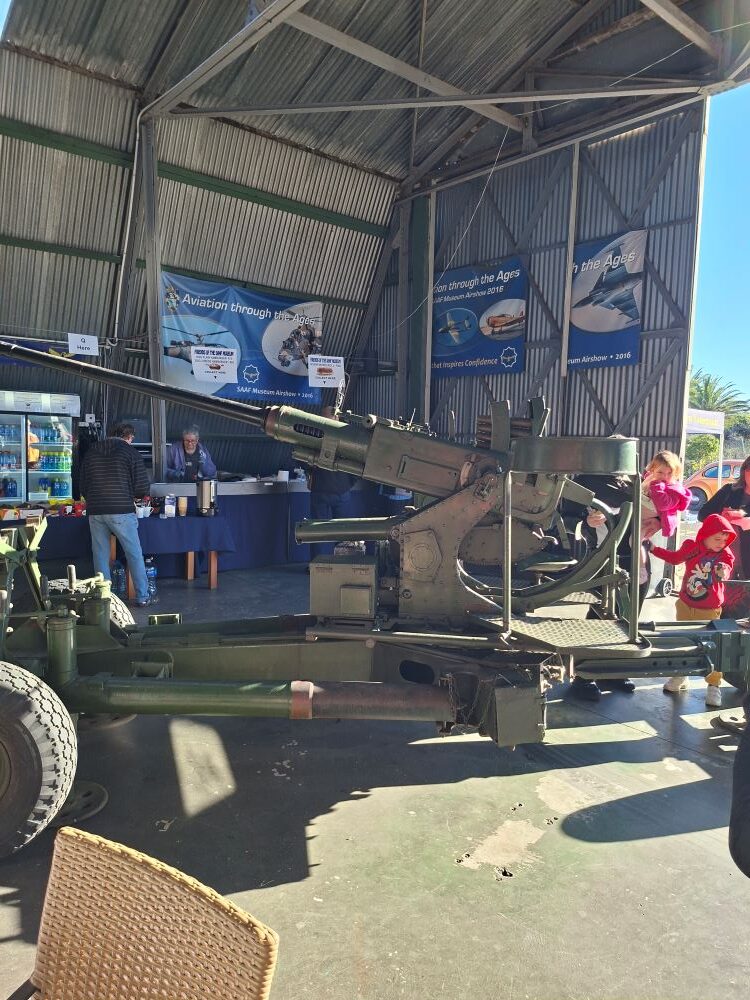 A vintage military anti aircraft artillery gun displayed inside an exhibition hangar at the South African Air Force Museum during a Wild Buggers club run.