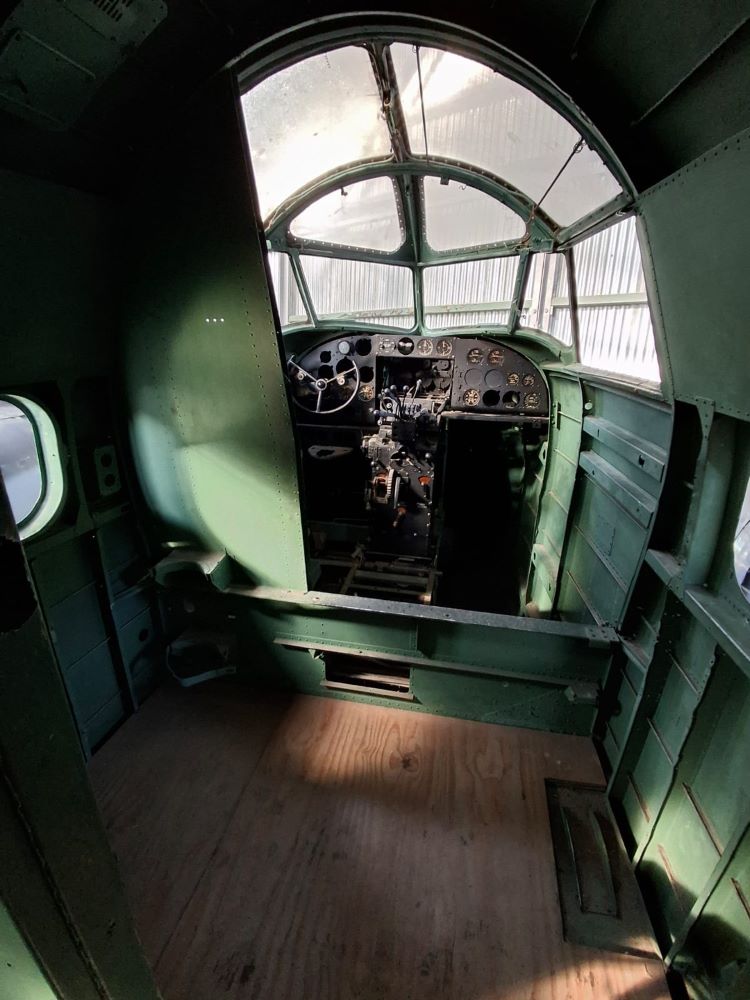 The interior cockpit and instrument panel of a vintage Piaggio P-166S Albatross military aircraft on display at the South African Air Force Museum during a classic VW air-cooled vehicle club run.