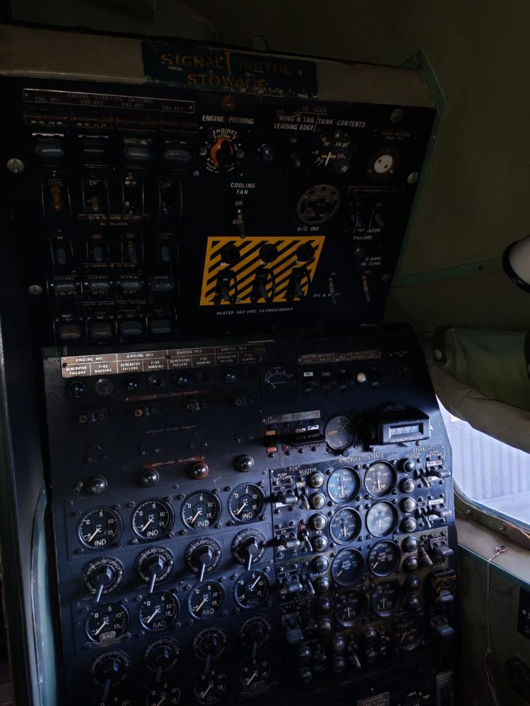 The vintage cockpit control panel and flight instruments of a four-engine Avro Shackleton aircraft on display at the Ysterplaat museum during a classic VW air-cooled vehicle club run.