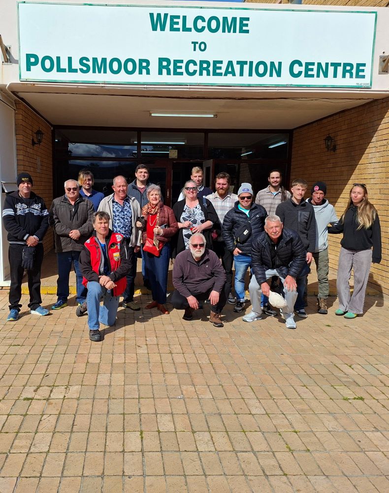 The Wild Buggers crew gathered outside the Pollsmoor Recreation Centre entrance for a group photo during the From Bars to Battleships run, featuring owners of custom beach buggies, Baja Bugs, and classic VW air-cooled vehicles.