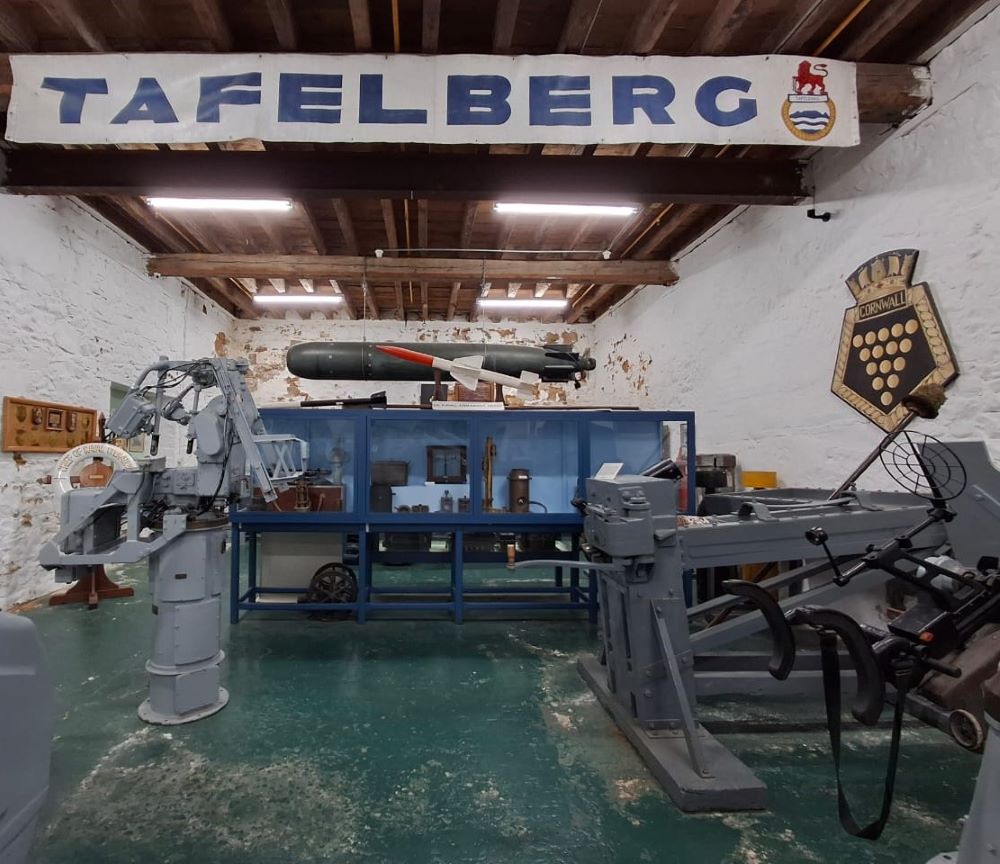 Historic naval exhibits and a missile display hanging from the ceiling inside the South African Naval Museum in Simon's Town.