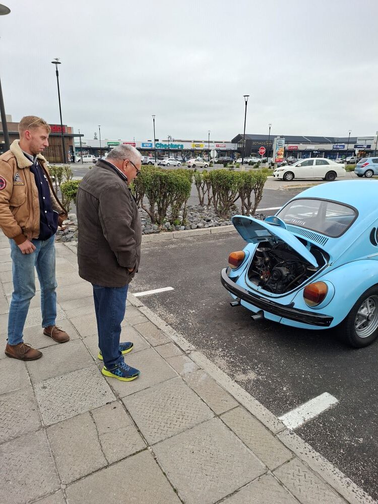 Kyle Cato showing Herbie his light blue classic VW air-cooled Beetle with a newly rebuilt engine before the From Bars to Battleships run.