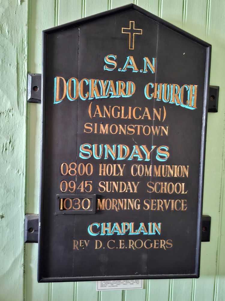 A hand-painted vintage wooden service board for the South Ancient Naval Dockyard Church in Simon's Town.