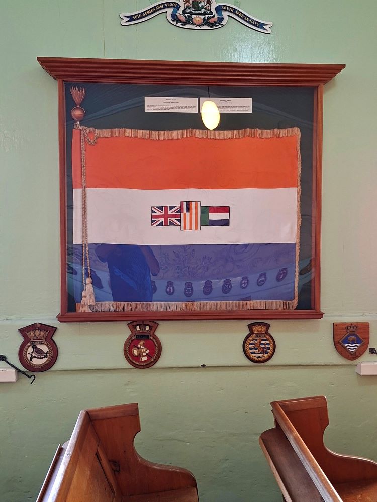The historical South African naval ensign framed on a wall inside the museum.
