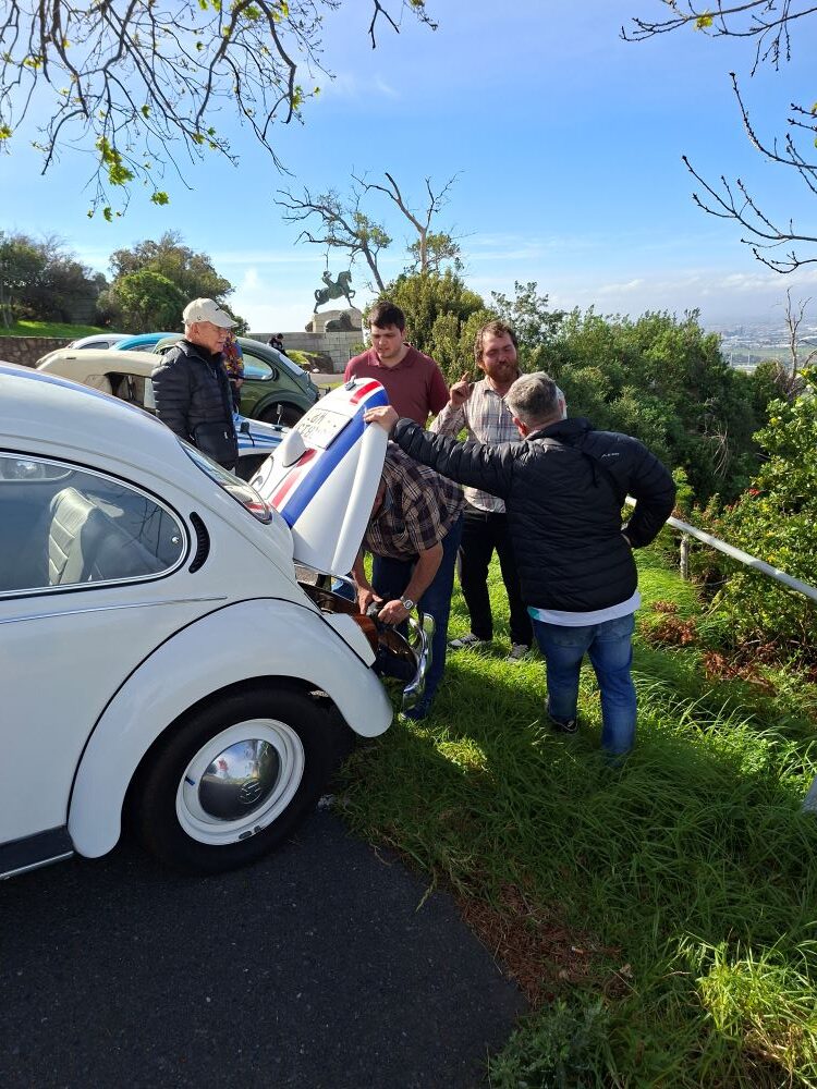 Neil and Maddox's iconic number 53 Herbie classic VW Beetle parked on the roadside during a club run.
