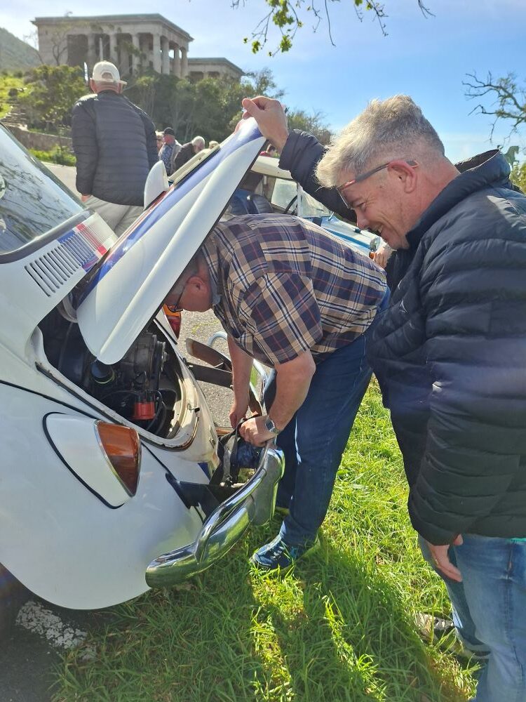 Herbie Thiart inspecting the engine of the iconic number 53 Beetle during a roadside stop.