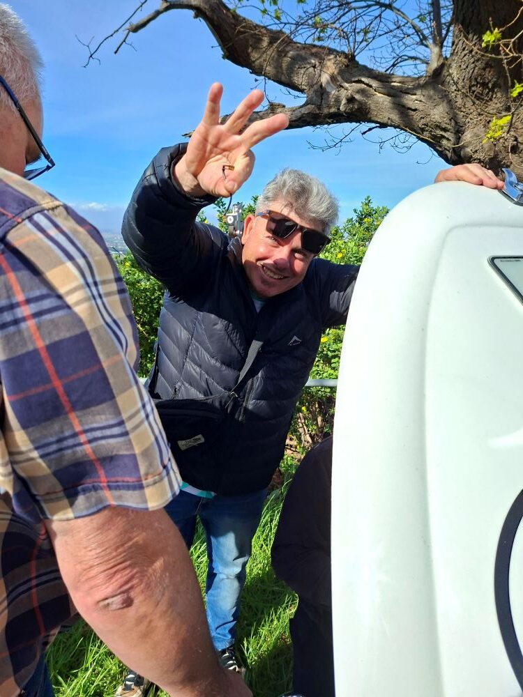 Neil holding up the culprit burnt points after tracking down the backfiring issue on his classic VW Beetle.