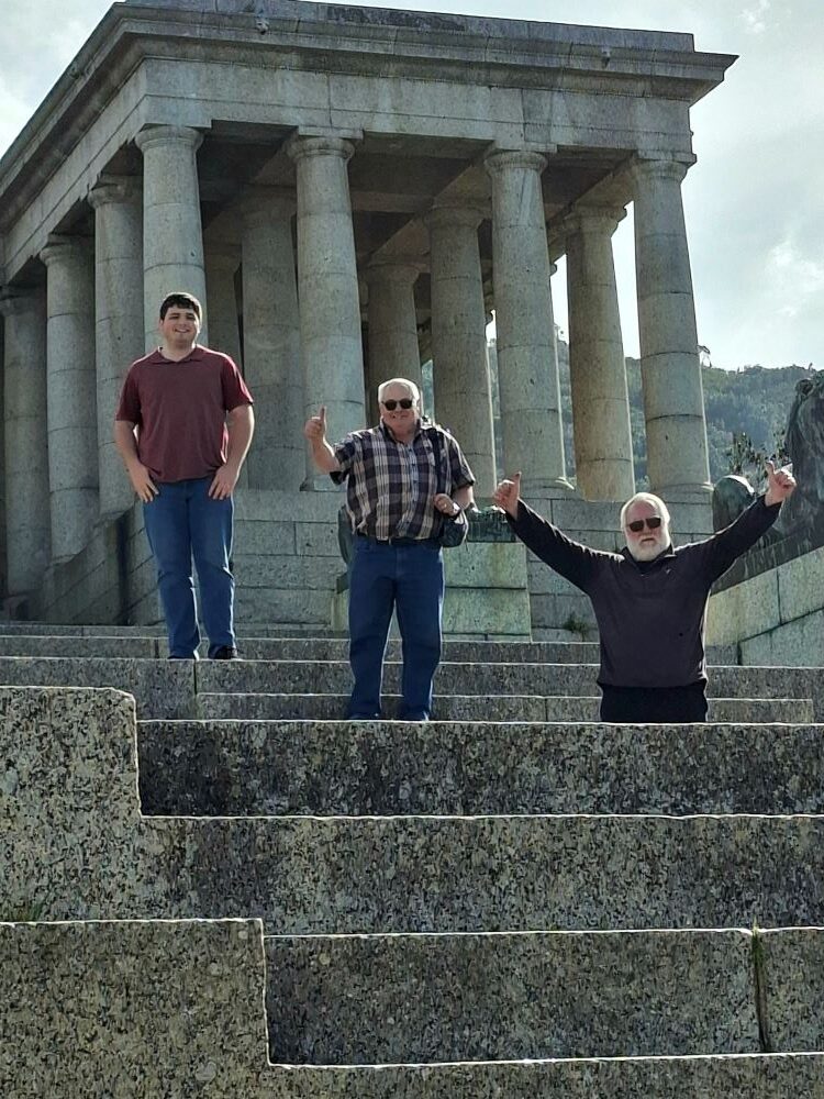 Heinrich, Herbie, and Leon standing at the top of the grand stone steps at Rhodes Memorial.
