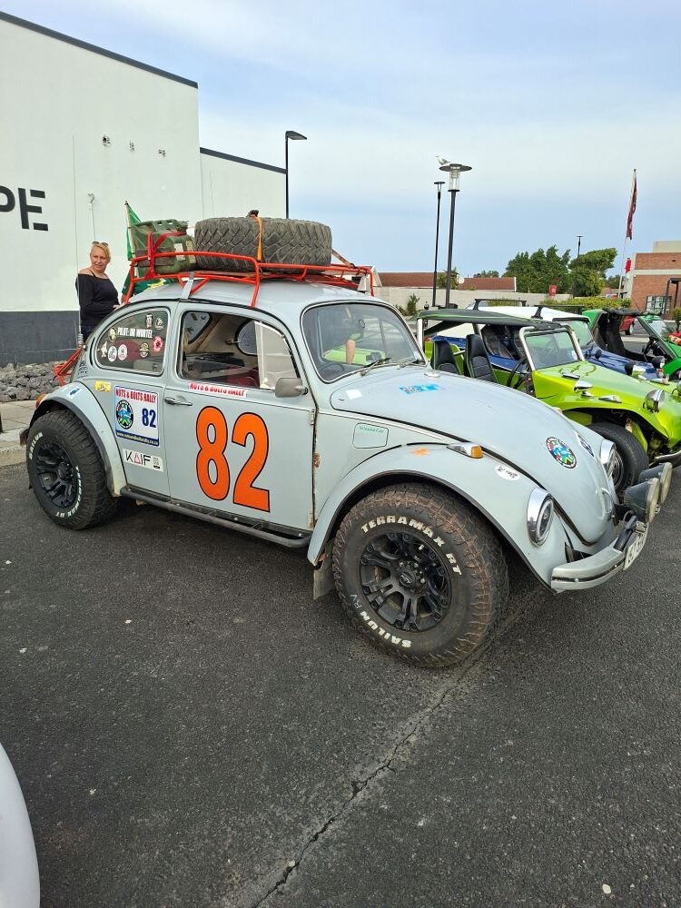 A classic air-cooled VW Beetle fully kitted out for the Nuts and Bolts Rally parked at the Bothasig meeting point.