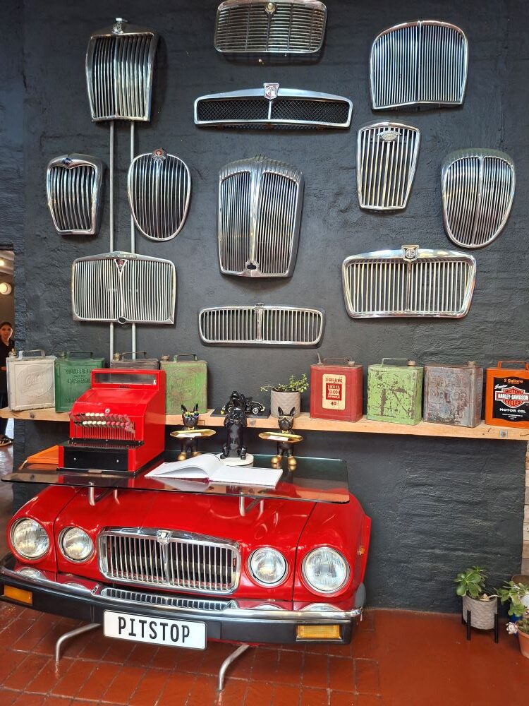 A wall display of vintage automotive grilles and car parts inside The Grille Shack at Pitstop during the club drive.