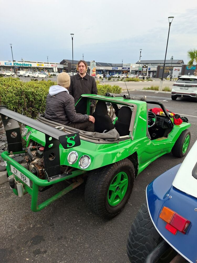 Anton and Jacques chatting by the green Kango beach buggy named Shrek parked at the Bothasig meeting point.