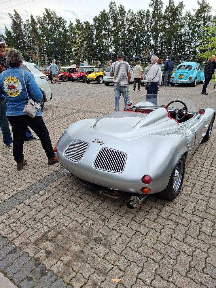 A silver Porsche Spyder replica parked alongside classic cars during the club stop at Klapmuts.