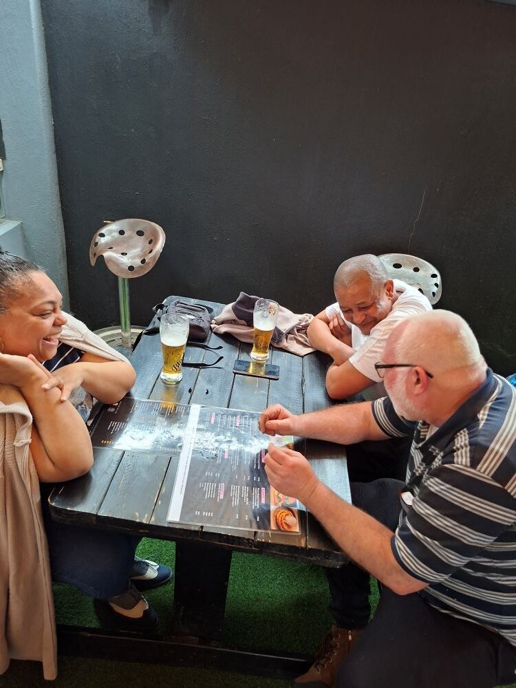 Club members studying the menu and getting ready to order drinks and food around a table during the stop.