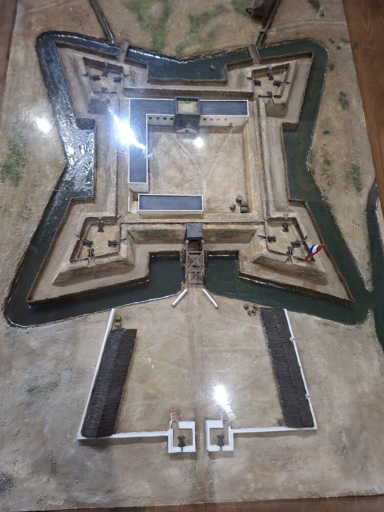 A top-down view of a detailed historical scale model displaying a five-pointed star-shaped fort surrounded by a moat.